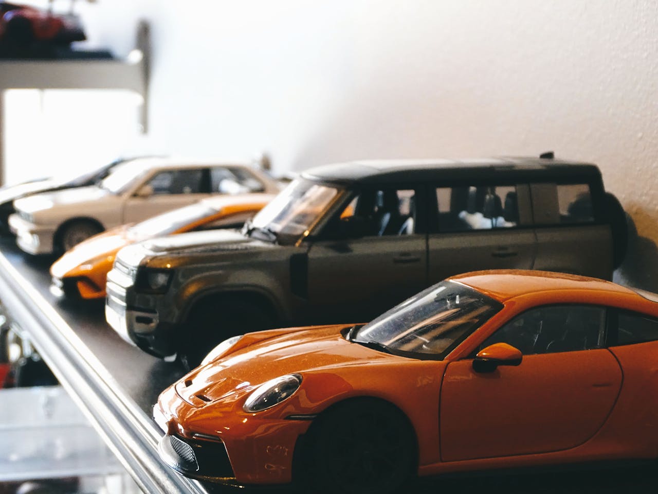 journey A detailed shot of model cars on a shelf, showcasing classic automotive design in Santiago, Chile.