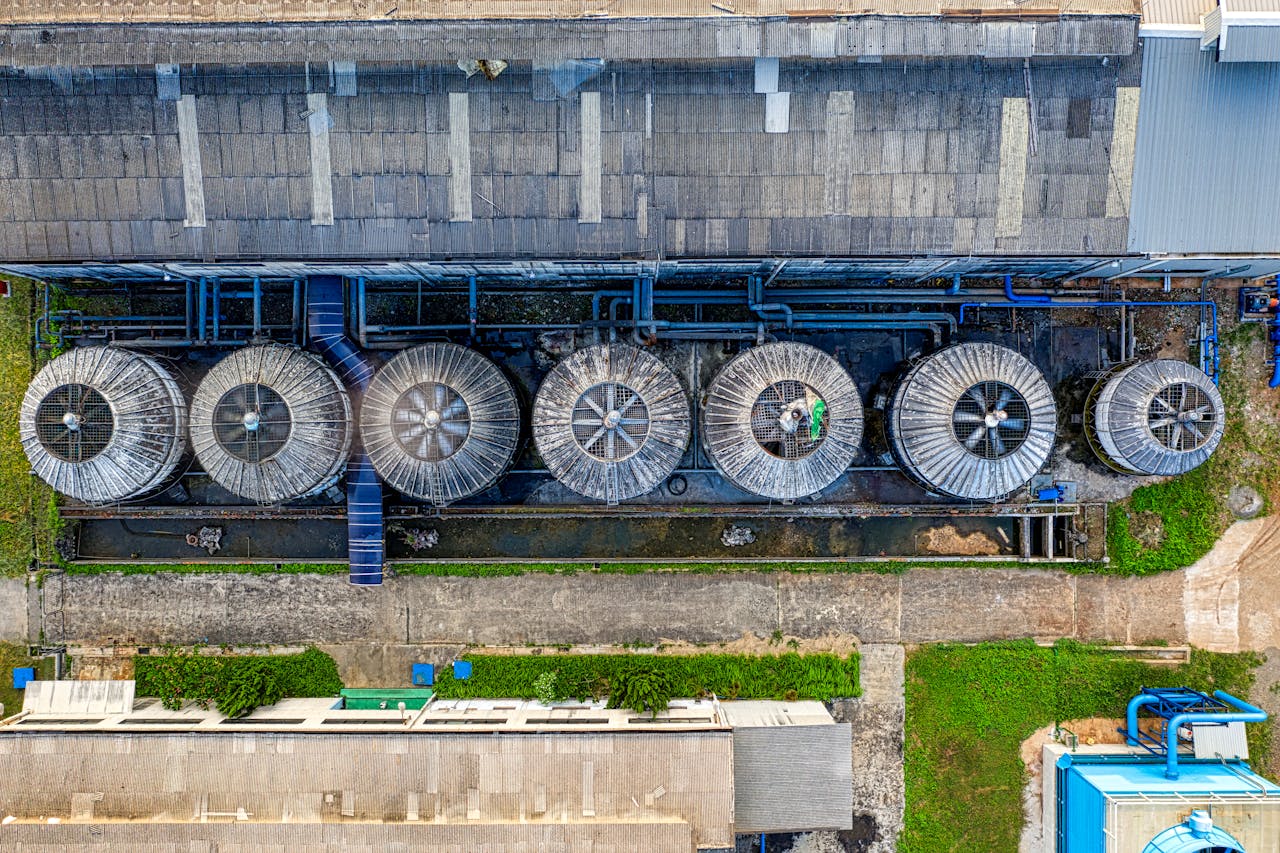 who-we-are Drone view of industrial terrain with treatment plants located in suburban area in sunlight